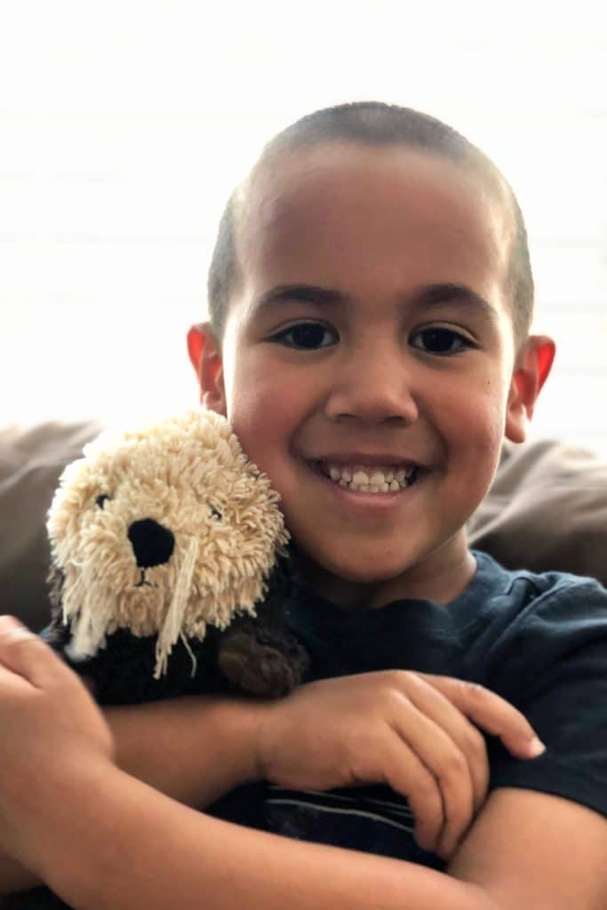 Jacob Cauich with his toy otter