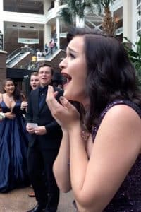 Marybel Lindsey reacts after realizing her date is in the background of her prom photos