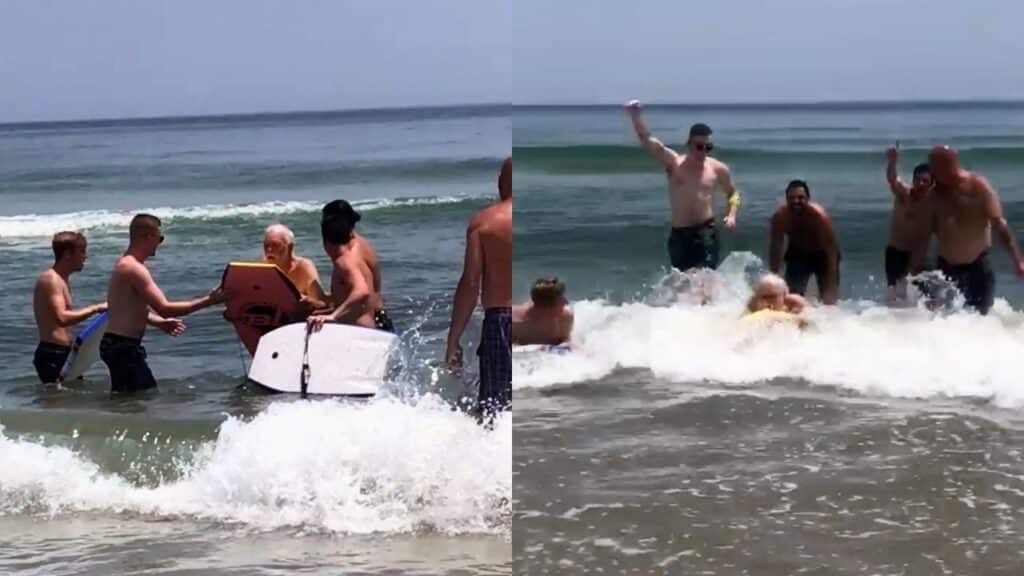 Beachgoers help Vernon to surf.
