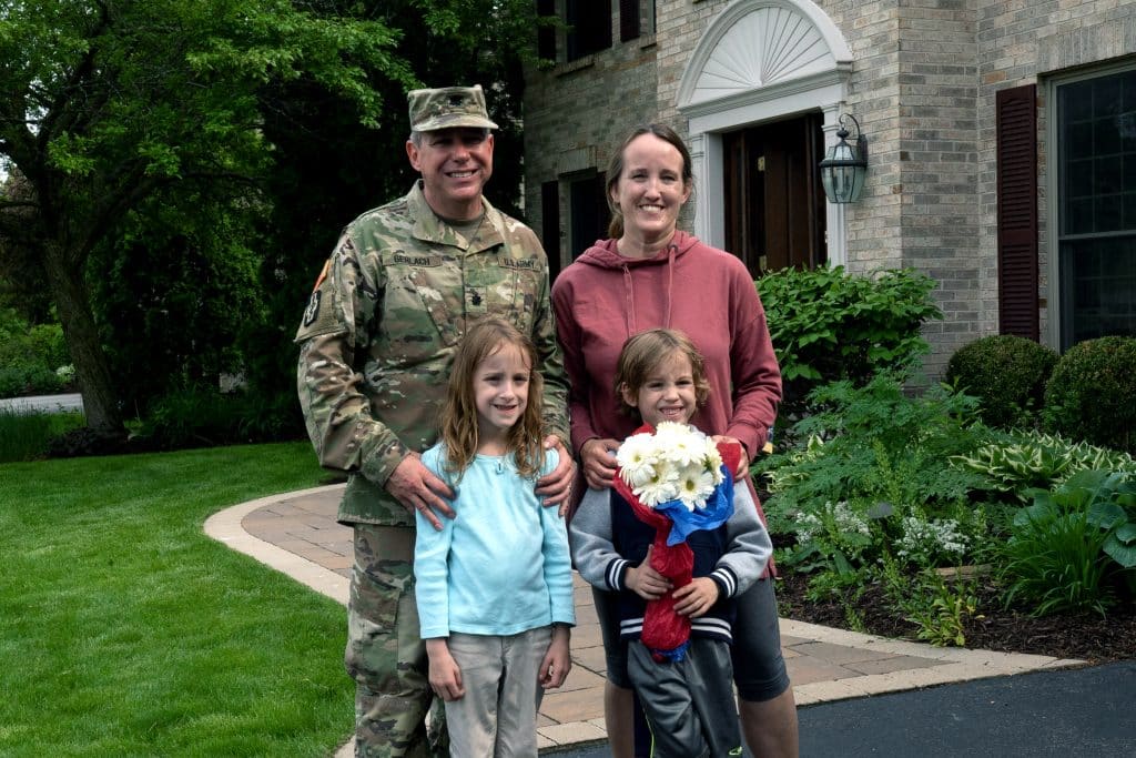 Rob with his family after he surprised his wife from the delivery box