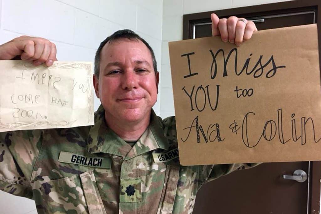 Lieutenant Colonel Rob Gerlach with signs for his children