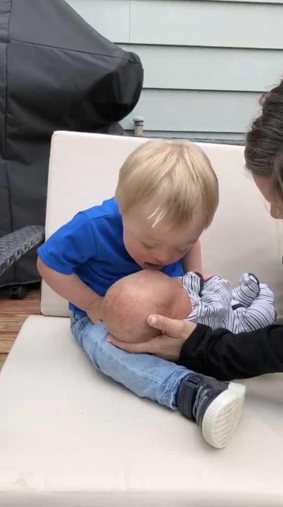 Baby with down syndrome meets brother