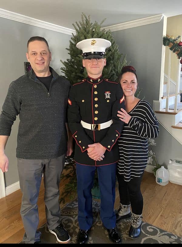 Marine with his mother and father at home