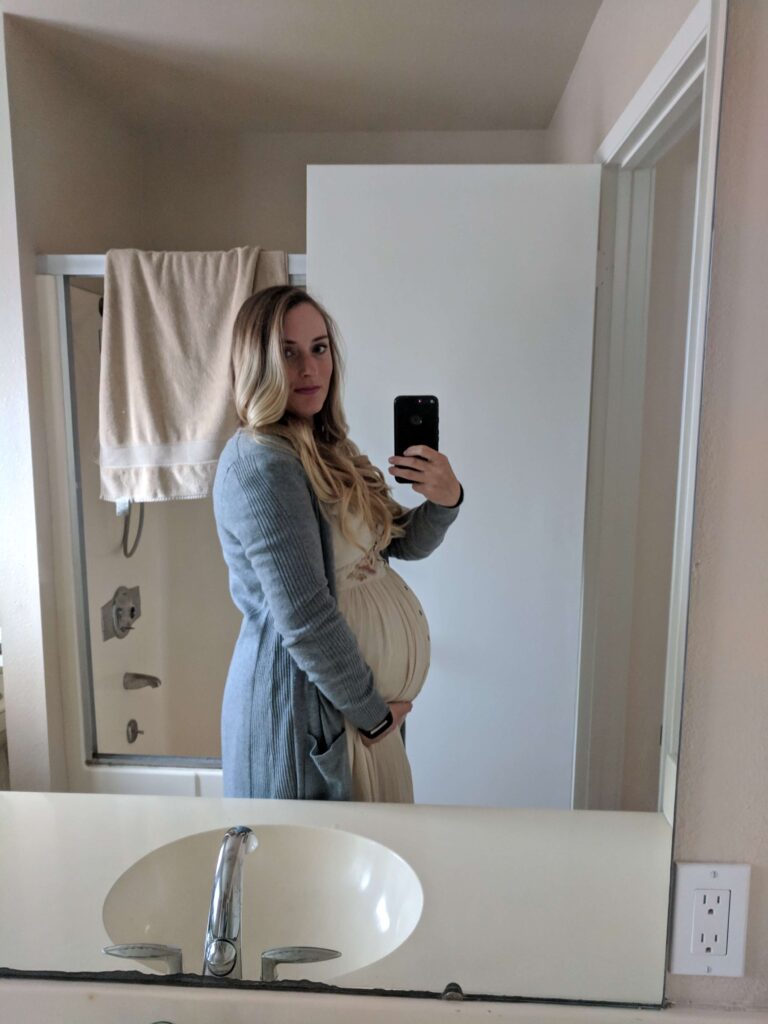 Tess selfie in the mirror while pregnant