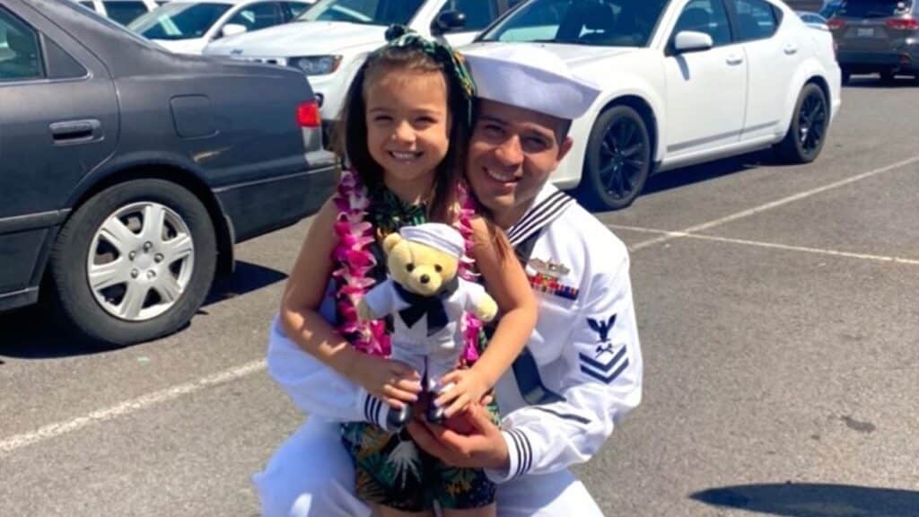 Lailah and her dad pose with the doll following his return from deployment.