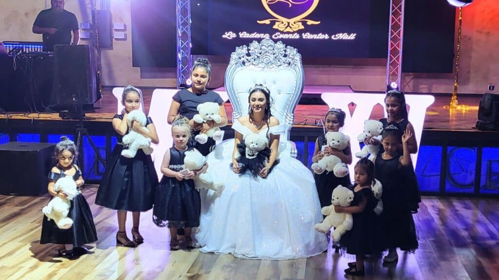 A girl crowns another at a quinceañera