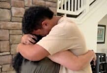 Max sobs on his mother's shoulder.