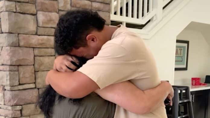 Max sobs on his mother's shoulder.