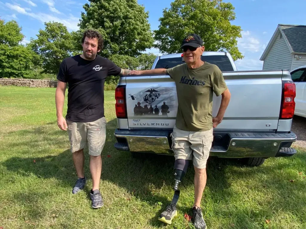 Jake and Kyle pose next to the truck artwork.