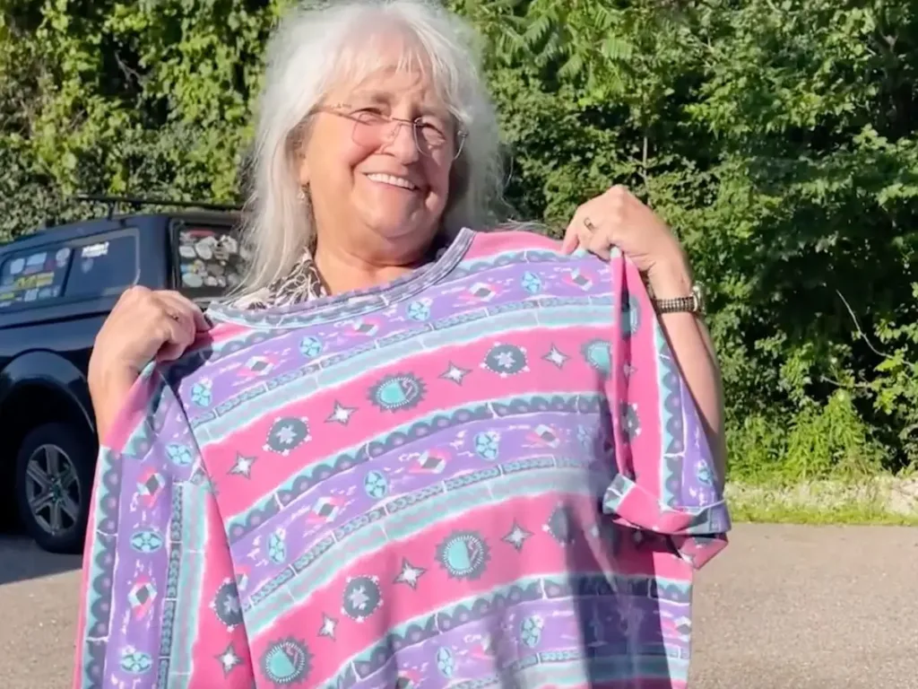 Linda holding the infamous t-shirt.