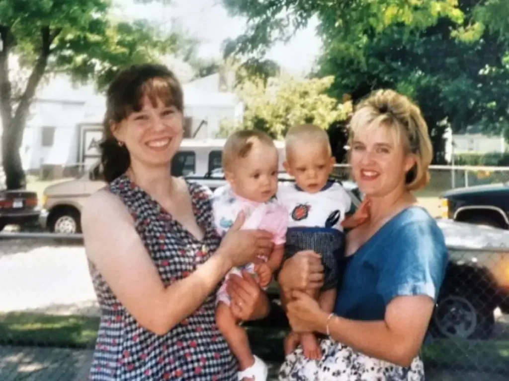 The couple's parents, Audra Sackey and Sherry Krambeck, holding Rachel and Hayden.