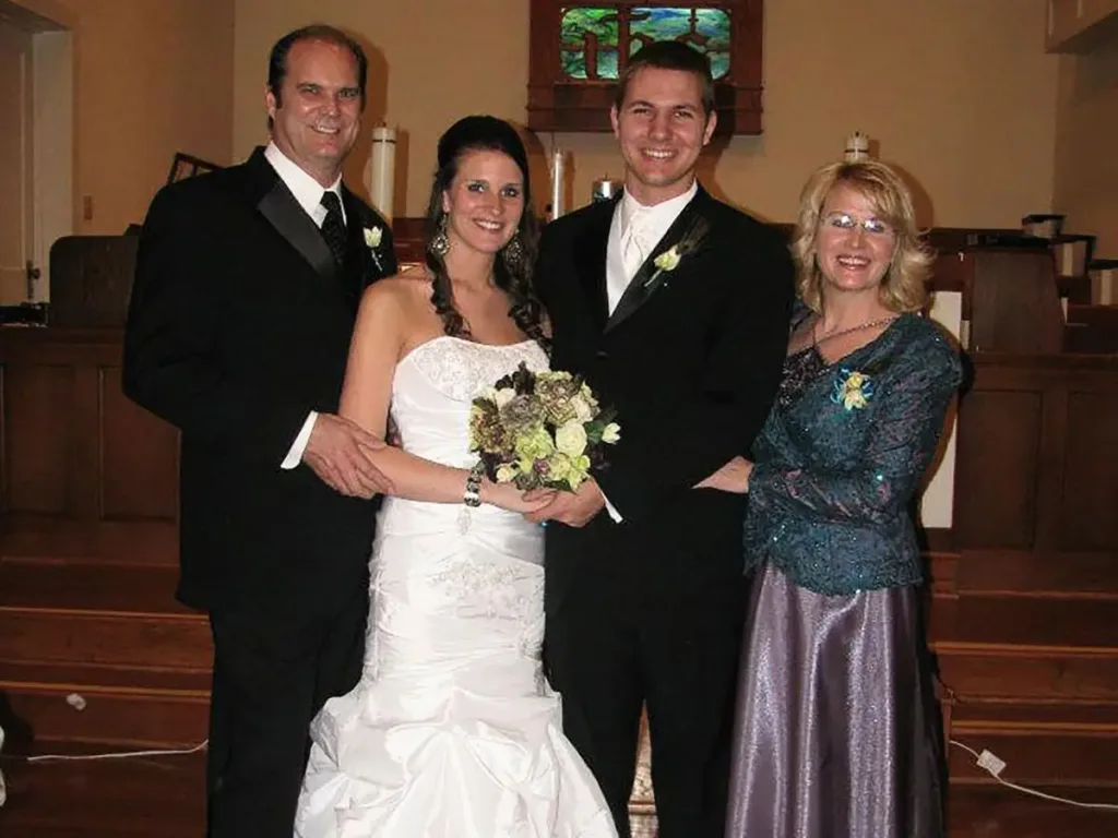 Bethany on her wedding day in the dress with husband Tyler and her mom and dad, Angie and Jeff.