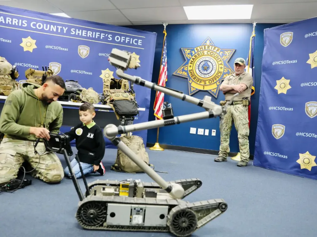 Romeo Gonzalez testing SWAT equipment with officers.