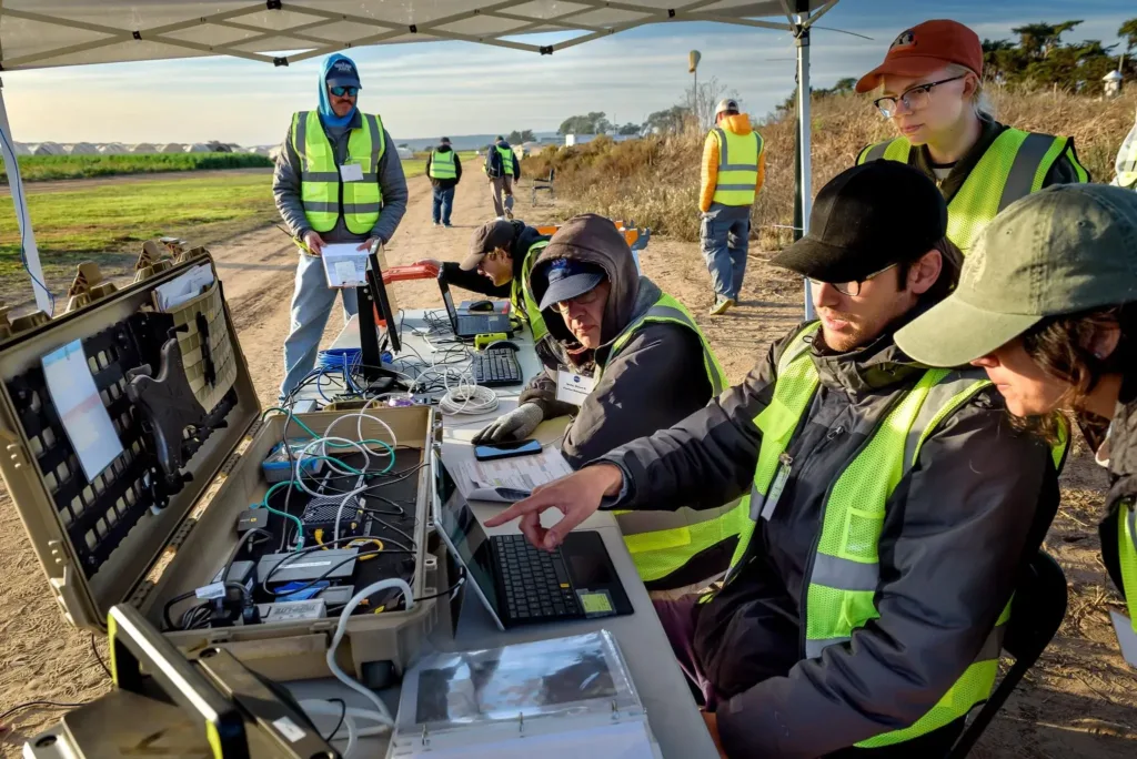 Yasmin Arbab front-right frame, Alexey Munishkin, Shawn Wolfe, with Sarah Mitchell, standing behind, works with the Advanced Capabilities for Emergency Response Operations (ACERO) Portable Airspace Management System (PAMS) case at the Monterey Bay Academy Airport near Watsonville, California.
NASA