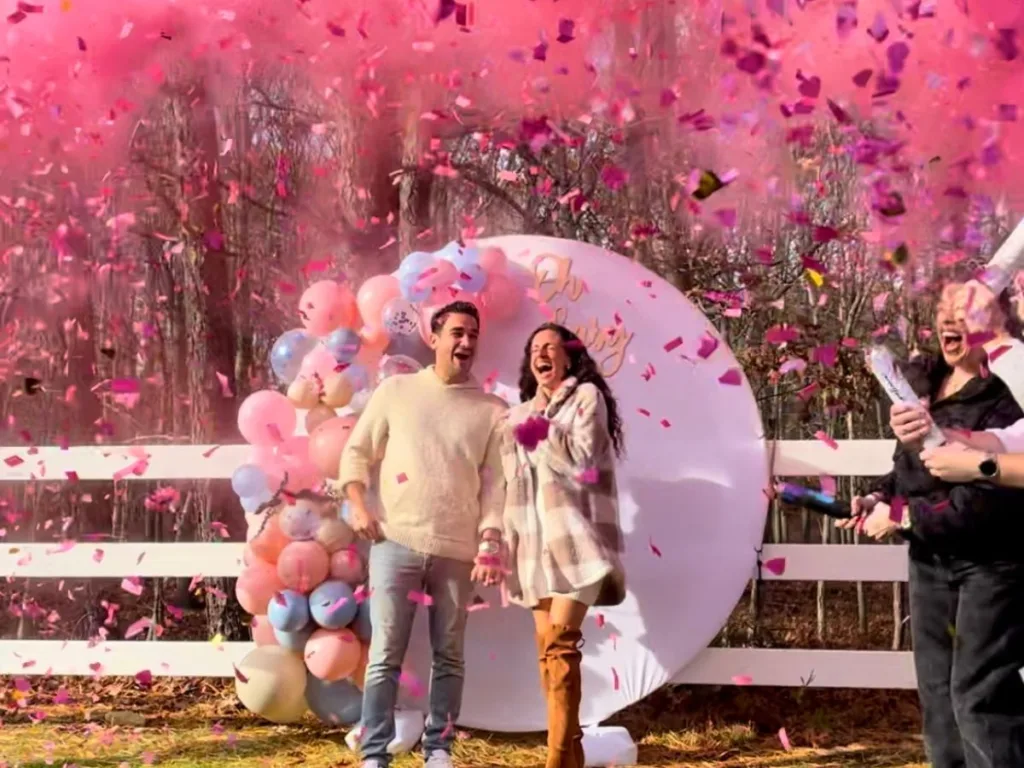 Confetti and pink smoke explode as couple learns they are having a girl