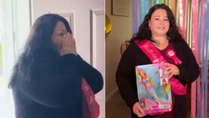 Alma Soqui smiles while holding a Barbie doll in front of rainbow decorations during her surprise birthday.