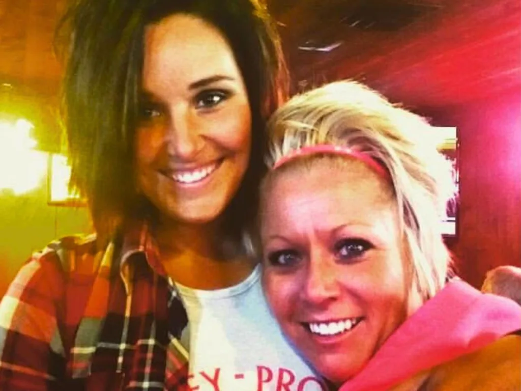 Trisha and Abby smiling in a cozy indoor setting from earlier in their friendship.
