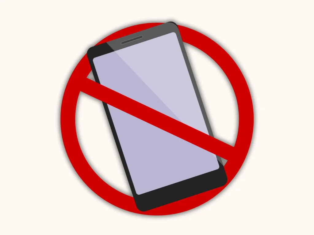 Graphic of a smartphone with a red prohibition symbol over it, illustrating the core message of digital detox ideas and limiting screen time.