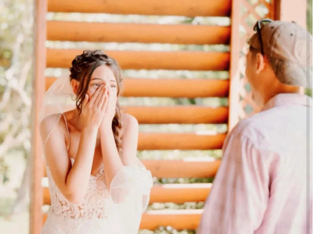 Bride turns around in shock during wedding first look moment.