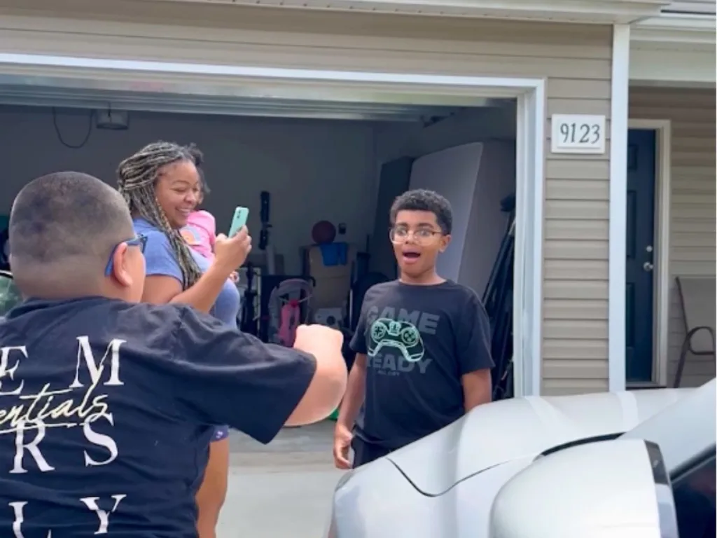 Boy reacts in shock while his mom films surprise reunion with best friend.