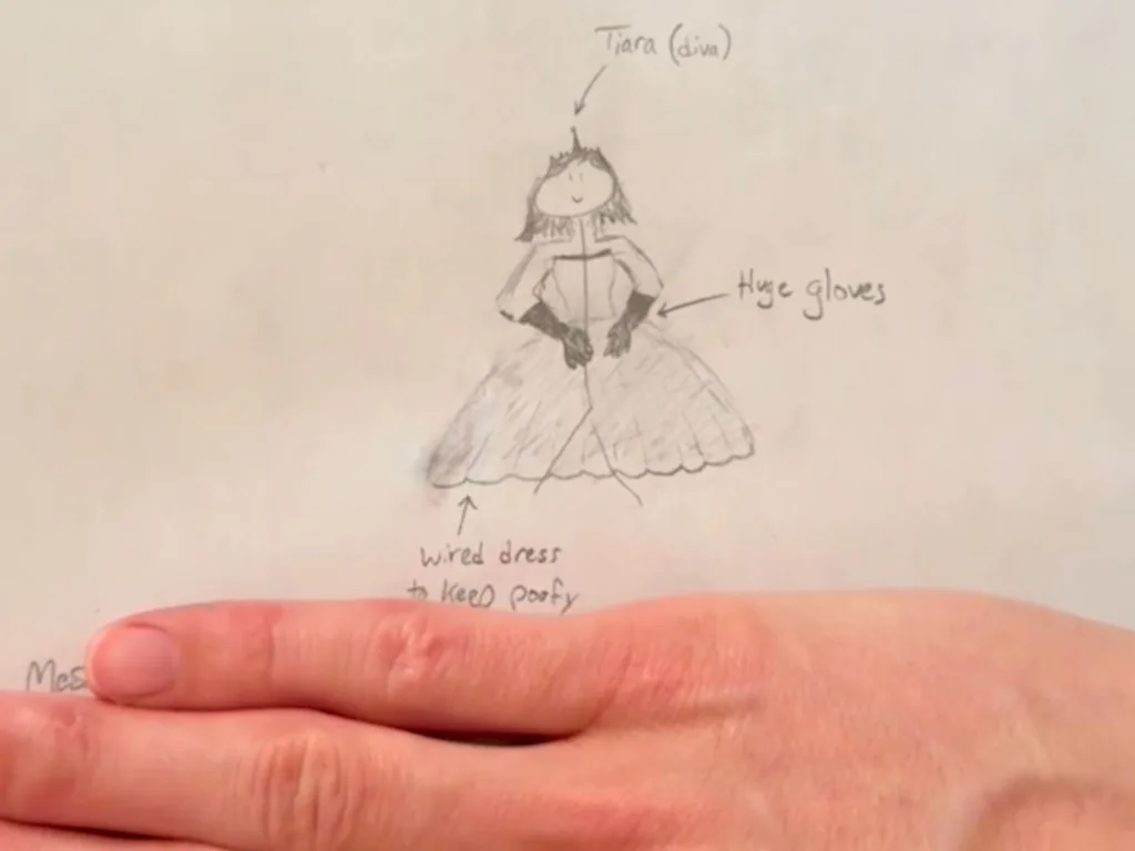 Close-up of a pencil wedding dress drawing labeled with notes like “tiara” and “huge gloves”