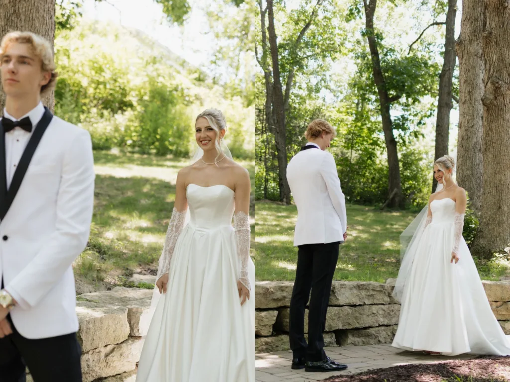Sitori in her wedding dress smiling behind Parker as he waits in a white tux jacket for a first look outdoors.