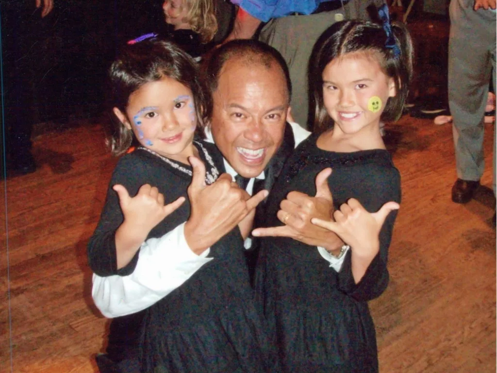 Rodney smiles with Violet and Kendra as the family poses together at a father-daughter ball.