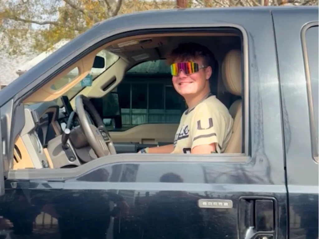 Levi smiles from the driver’s seat of his late father’s truck after being reunited with the vehicle.