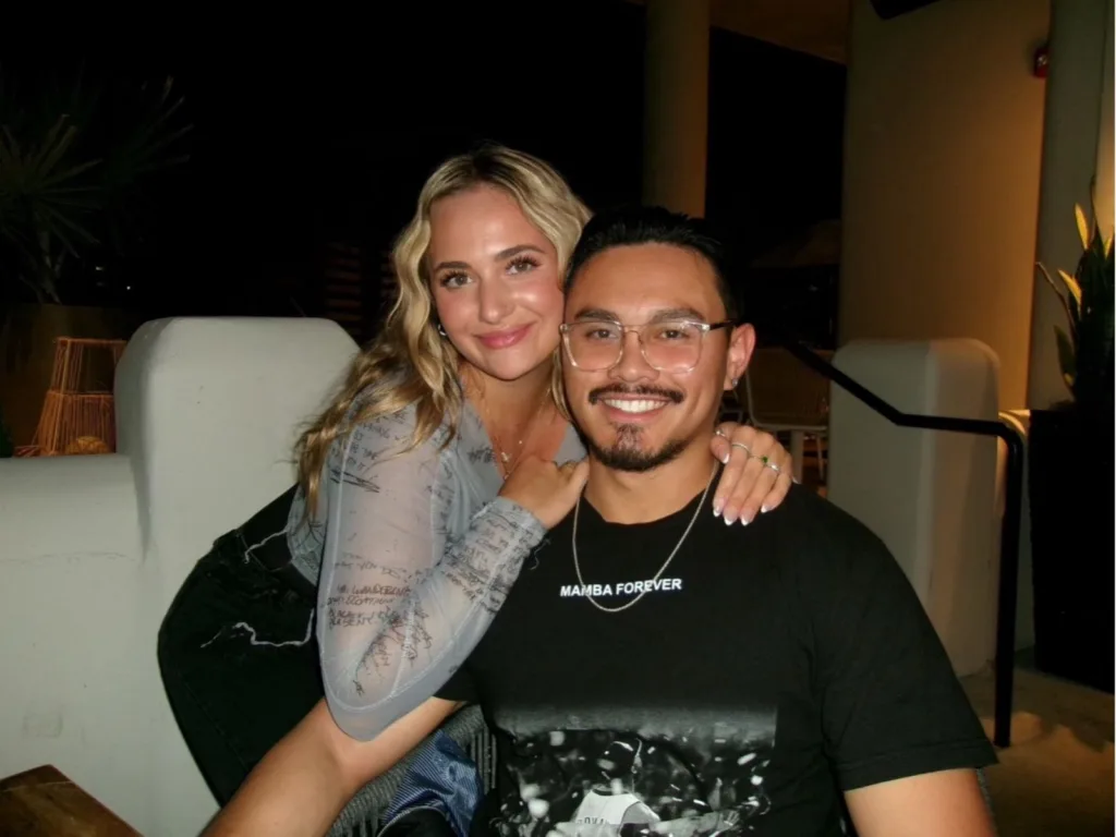 Railey poses with Christian in a smiling portrait indoors.