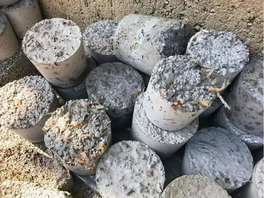 Composite showing Waste Light Concrete cylinders alongside a Vögele paving machine on site.