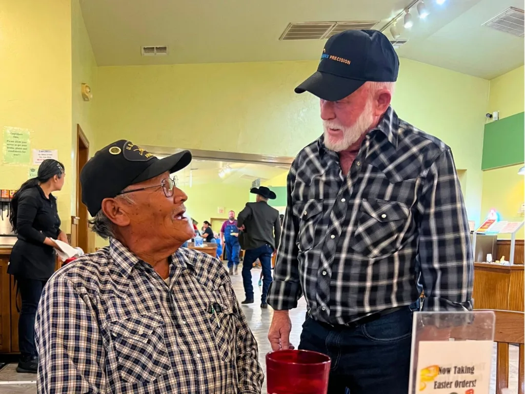 Close-up of Melvin and Ronnie smiling together after their emotional reunion at the restaurant