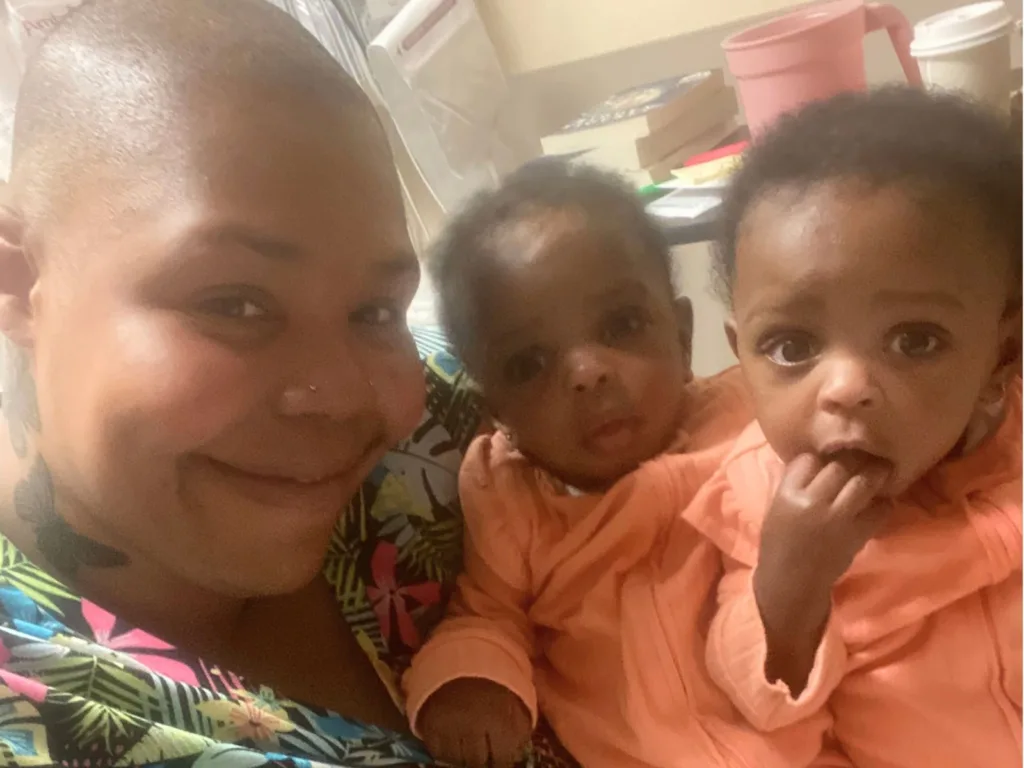 Monique smiles for a selfie with baby twins Teagan and Tatum during a hospital visit for Brittany.