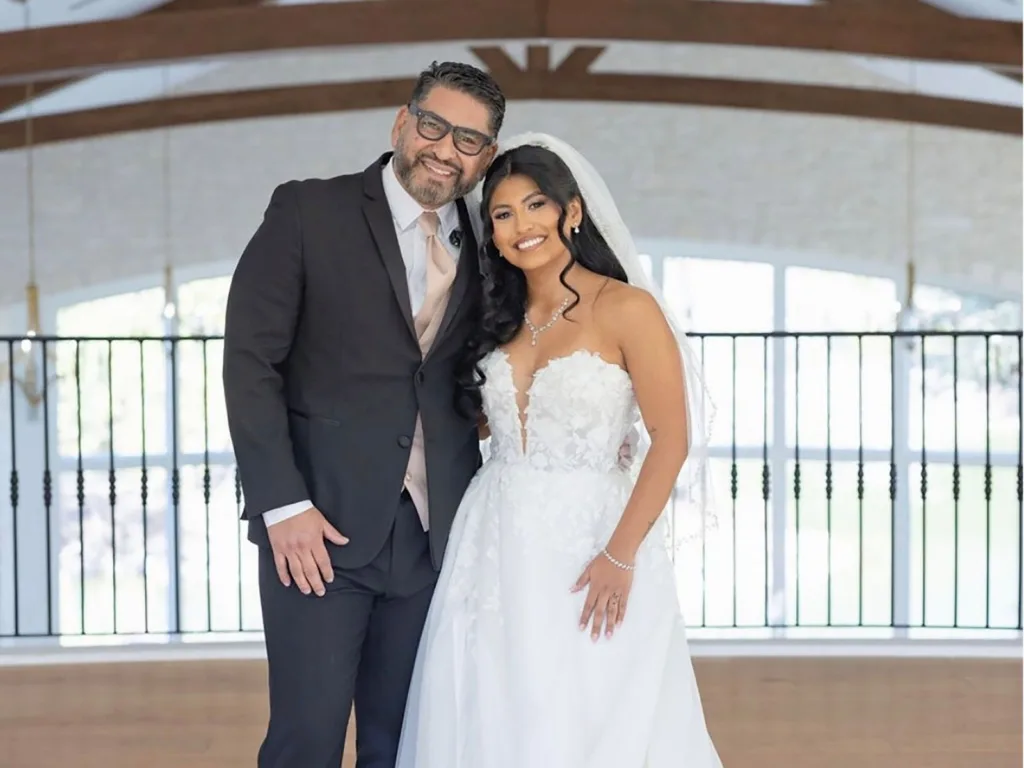 Adrian and Adrienne pose together in their wedding attire after the ceremony.