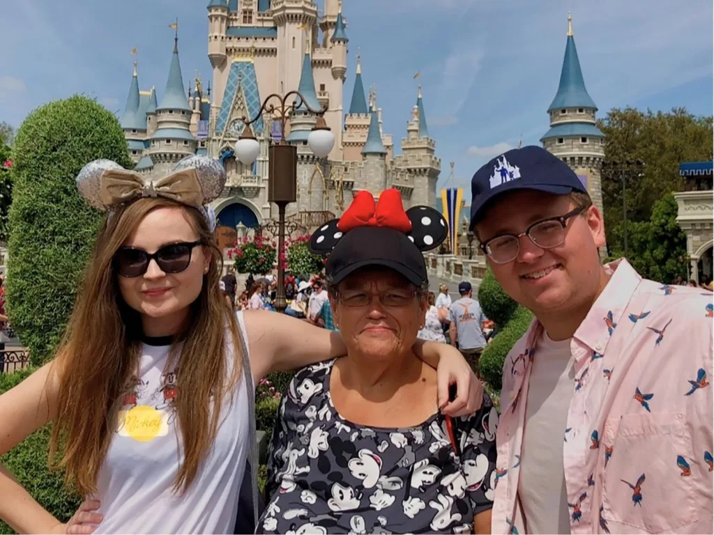 Samantha, Tonja and Nick pose together in front of Cinderella Castle during a family trip to Disney World.