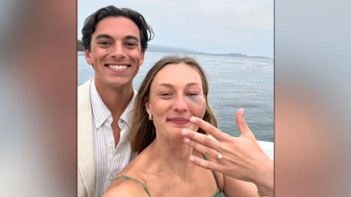 Jessica shows off her engagement ring beside Mark by the water after being hit in the face by a rogue golf ball earlier that day.