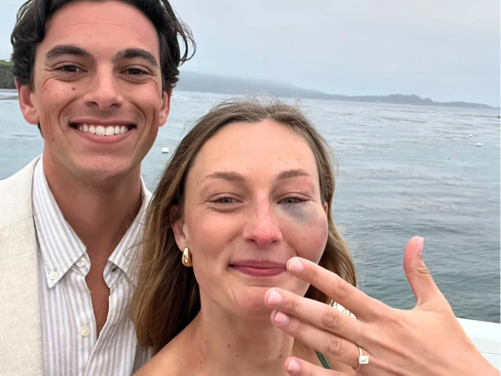 Jessica and Mark take a selfie by the water after their proposal, with Jessica holding up her engagement ring.
