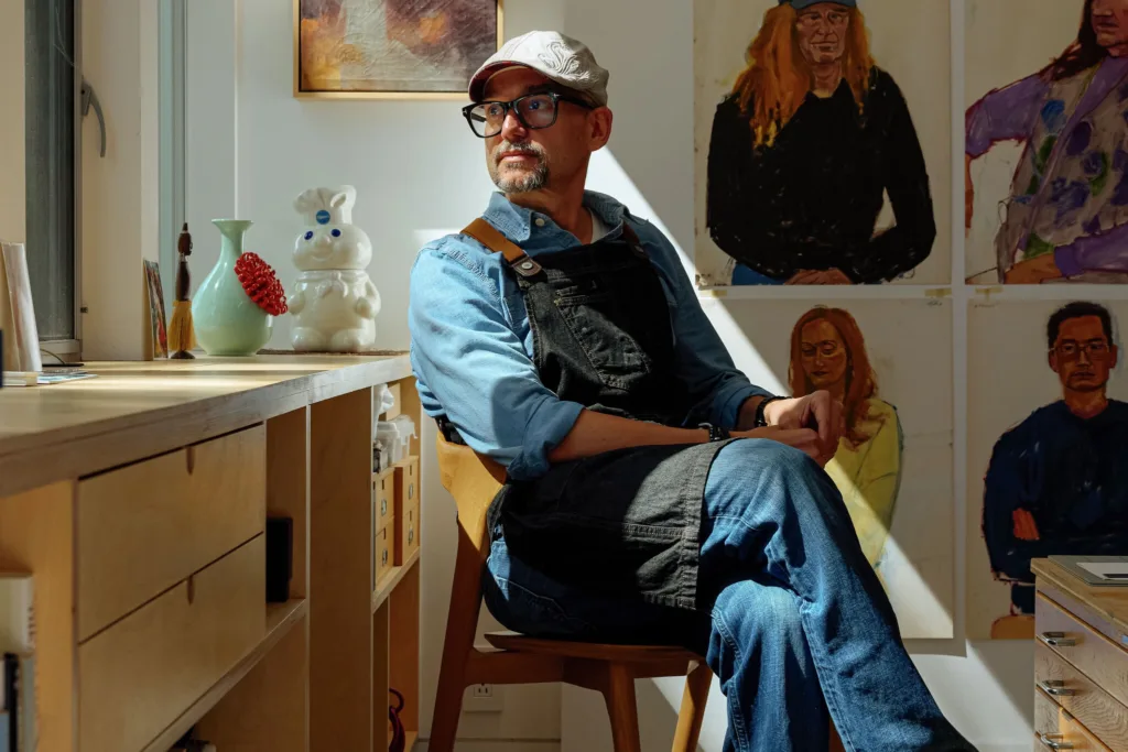 Vincent Serritella with his paintings of Sutter Health employees
