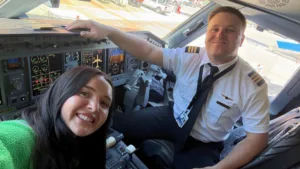 Hannah takes a selfie with Mason in the cockpit after he completed his first commercial flight.