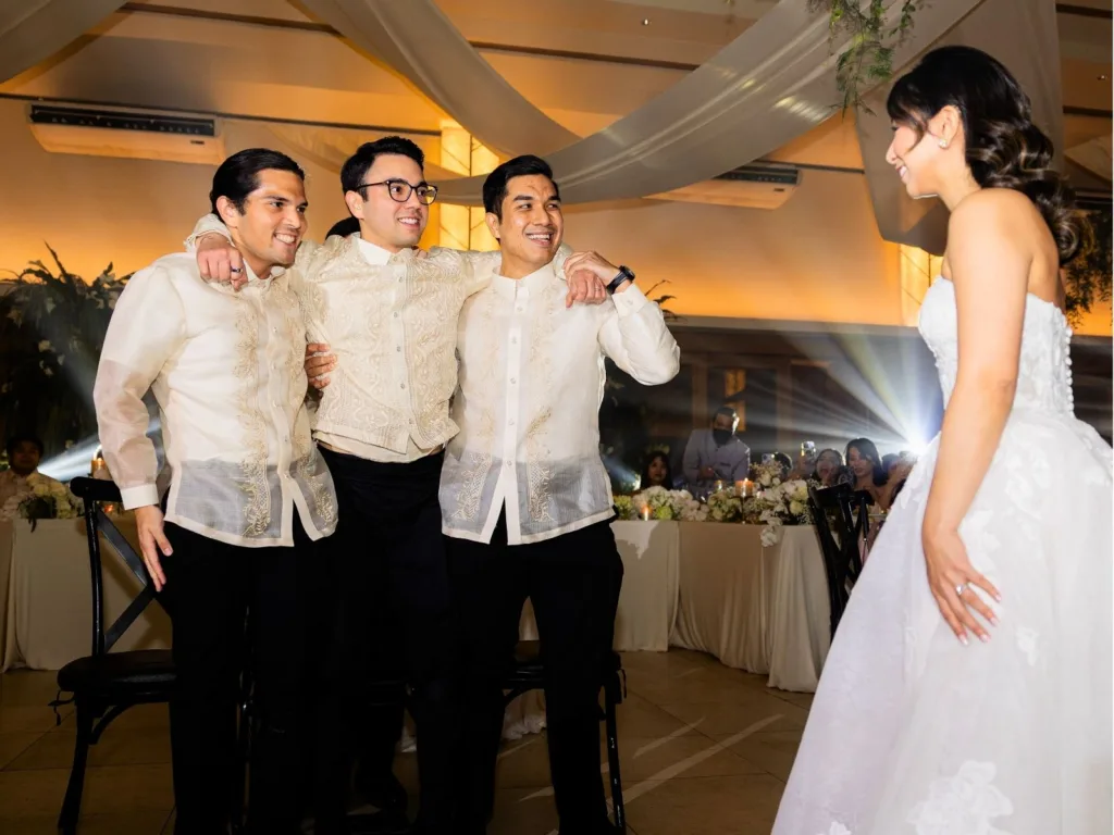 Andy’s groomsmen stand beside him as Michelle watches during the emotional first dance surprise.